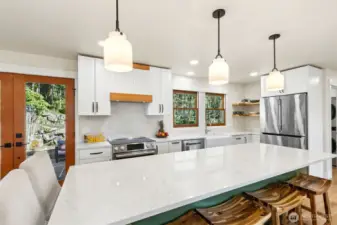 Updated island kitchen with quartz countertops and modern finishes.