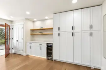Coffee bar, wine fridge, and extensive cabinet storage.