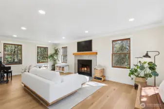 Spacious living room featuring a wood-burning fireplace.