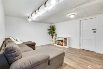 Finished and thoughtfully updated, this basement offers easy-to-maintain flooring, making it the ideal flex space. Whether you're envisioning an at-home theater, a dedicated office, or a fun-filled playroom, this area adapts effortlessly to suit your needs. The door leads to the two-car tandem garage.