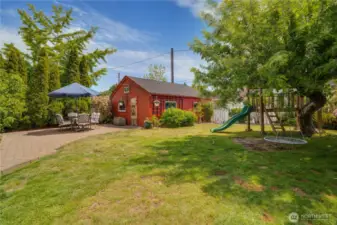 Expansive and versatile backyard oasis—perfect for play, creativity, and relaxation! Features a charming play structure for endless fun, along with a detached, freshly painted workshop that’s ideal for hobbies, storage, or a personal retreat.