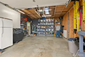 Attached garage. Custom Shelving  Two Velux skylights  Codel entry door fiberglass 3-lite windows, custom workbench, pegboard and shelving