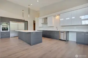 Quartz 2cm Kitchen Counter • Full Height Custom Backsplash • Inspired Pendant Lighting Over Kitchen Island • Walk-In Pantries