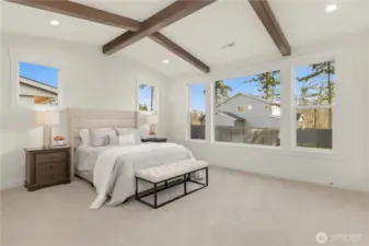 Beamed Ceiling are vaulted in the Primary Suite creating a spacious feel to the room.