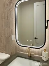 More Tech lighting in the Powderroom around the modern Mirror.