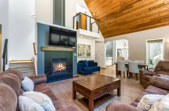 This room includes a gas fireplace for cozy evenings. Note the second floor balcony.