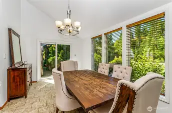 The holiday sized dining room with the view of the beautiful grounds. Doors lead to the covered patio.