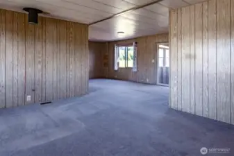 The front door opens to a large living and dining area.