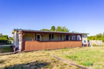 Back of home has a large covered back deck.