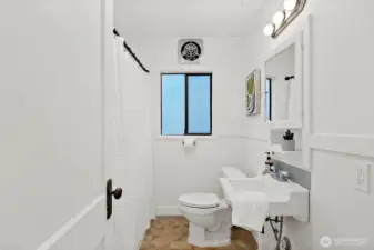 Bathroom includes a modern shower setup.