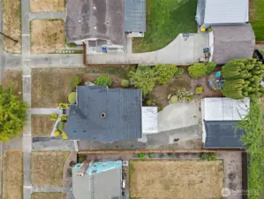 Backyard has a green lawn with a patio.