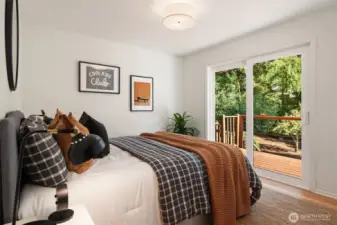 Northeast bedroom on main floor with slider to deck overlooking gardens.