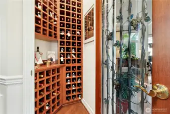 Behind a glass and custom iron door awaits a wine room designed for the true connoisseur.