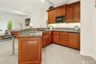 Generous wet bar, the size of a small kitchen, ideal for entertaining or hosting out-of-town guests with ease.