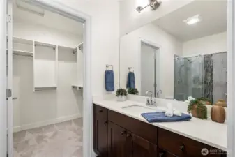 The spacious primary suite offers a thoughtful layout with direct access to the private 3/4 bath and a generous walk-in closet. Soft carpeting and neutral finishes create a calming retreat within the home.