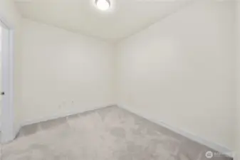 This bright secondary bedroom offers a clean, versatile layout perfect for creating a quiet workspace, guest room, or hobby area. Soft carpeting and neutral colors enhance comfort while providing a blank canvas for your personal style.