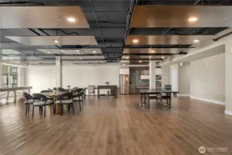 This expansive community room offers multiple seating areas, game tables, and an open layout perfect for hosting gatherings or social events. Modern finishes and warm wood flooring create an inviting atmosphere for residents to enjoy year-round.