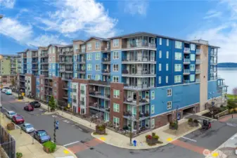 A sweeping aerial view highlights the Baker Building’s position within the Point Ruston neighborhood, surrounded by walkable paths, vibrant community spaces, and scenic shoreline. This location offers a rare blend of coastal beauty, outdoor recreation, and convenient access to local dining and entertainment.