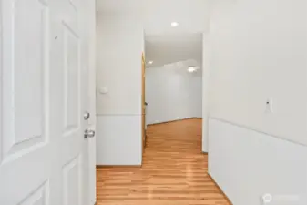 Entryway with kitchen off to right, hallway to half bathroom, utility room and garage entry to the left. Straight ahead into living room with staircase to upstairs bedrooms right before entering living room.
