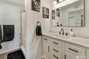 Primary bath has updated vanity, walk-in shower and its' own walk-in closet