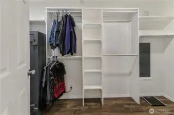 Convenient Built-ins make the large walk-in closet extra functional.