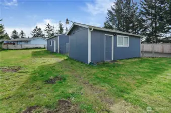 Additional shed provides space for hobby, storage or office.