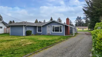 Side drive provides access to she and shop and provides room for RV storage.