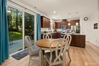 Breakfast nook space between kitchen and living room with access to slider leading you out to the backyard.