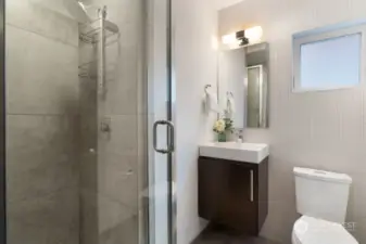¾ bathroom with designer tiled shower.