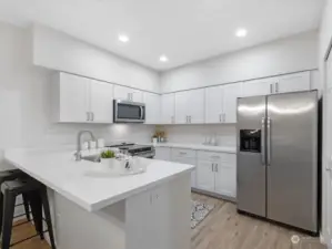 This kitchen is amazing. With more than generous cabinetry and work space, all new cabinetry and gorgeous counters, new range and microwave, excellent lighting, you'll love creating in this space.