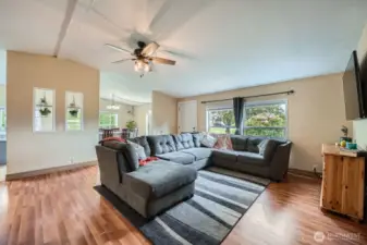 View of the living room looking toward the front door and dining room.