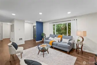 Looking towards the front entry from the living room. Bedrooms down the hall to the left.