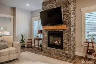 Propane fireplace with stone surround provide a focal point in the space. Plantation shutters really elevate the home.