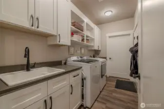Laundry room with utility sink and lots of storage