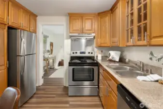 The kitchen features lovely oak cabinets, quartz cabinetry and brand new stainless steel appliances.