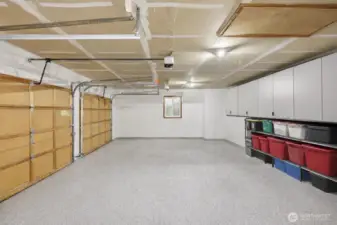 Epoxy floors and added storage. This photo has been adjusted to remove the seller's belongings currently being stored in the garage.