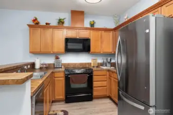 Kitchen features a full size pantry on the opposite wall.