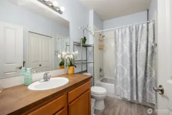 Spacious full bath with large closet for storage on the opposite wall.