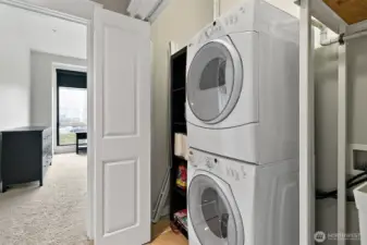The closet is equipped with a full-size stackable washer and dryer, offering ample space for laundry and additionally a convenient stand-alone sink providing functionality for handwashing or cleaning up after projects.   Washer and dryer remain with the sale of the condo.