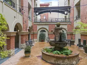 This courtyard offers a taste of European elegance with lush greenery, a beautiful fountain and timeless architectural details.