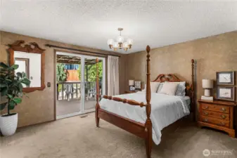 Primary suite on main level with sliding door access to back deck.