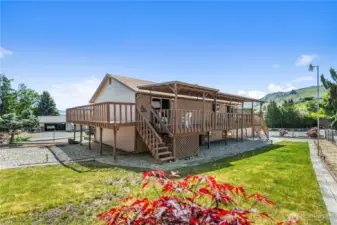 Cozy fenced back yard with wrap-around deck.