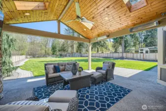From the outdoor room, enjoy a spacious, fully lawned backyard where adults can envision building a pickleball court and kids can set up a lively whiffle ball game—perfect for active family fun and outdoor living.