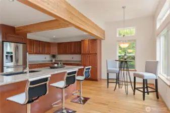 There is sufficient space for a kitchen table and additional bar stools at the island.