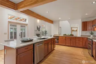 French doors from the kitchen open to an extensive covered deck, ideal for hosting events.