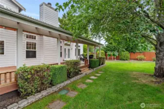 The backyard is well-maintained and includes two garden sheds, which are located on the side of the house and not visible in the picture.