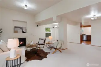 The view from the front door highlights the large living and dining rooms, leading into the kitchen.