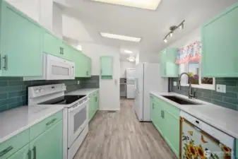 Updated kitchen with Corian countertops and newer appliances.