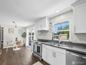 Lots of windows, this cheery kitchen  opens to back yard