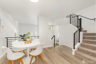 Open and airy layout with modern railings, fresh flooring, and a stylish dining area that connects seamlessly to the living spaces.